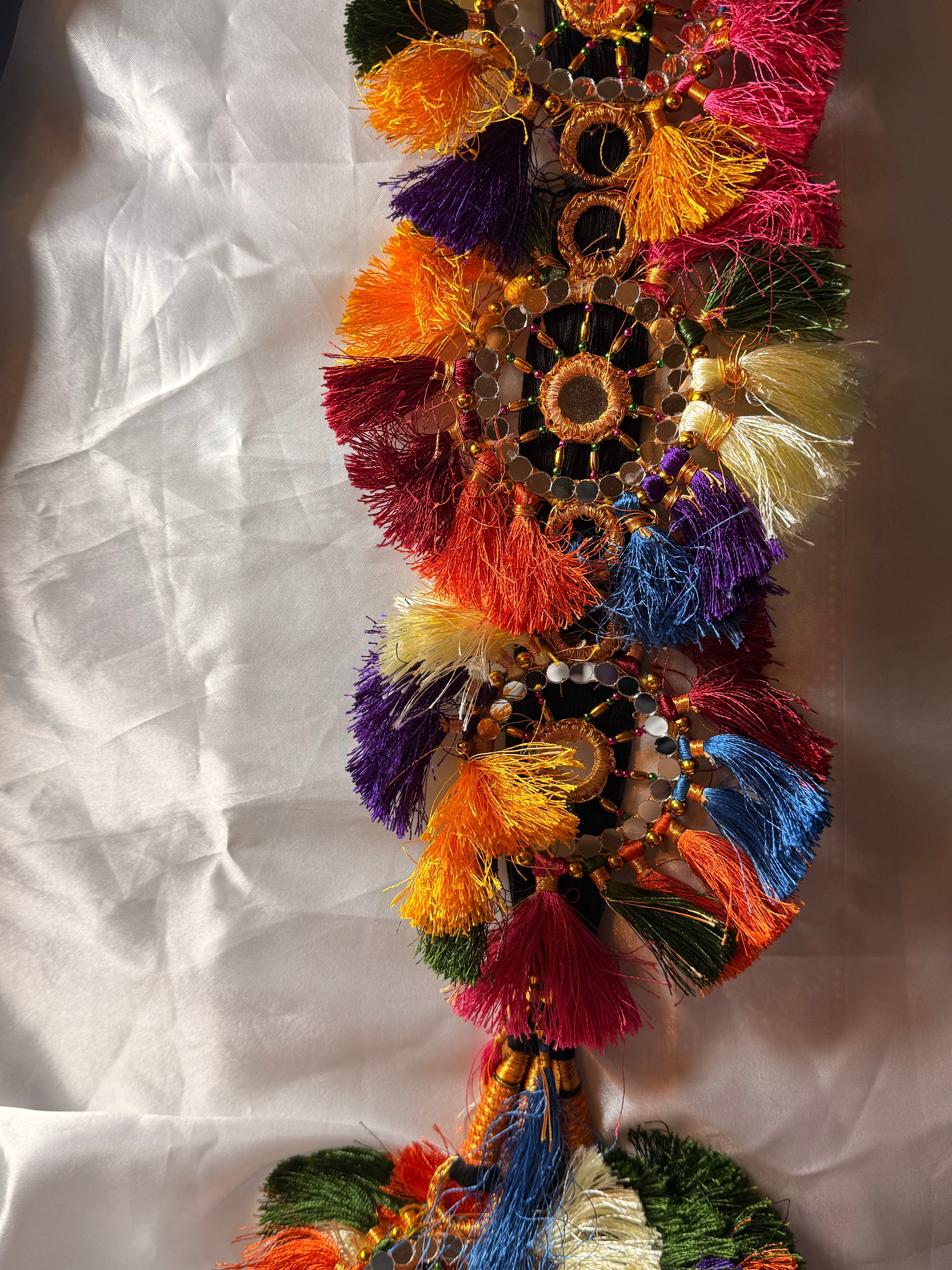 Colorful decorative garland with tassels on a white background