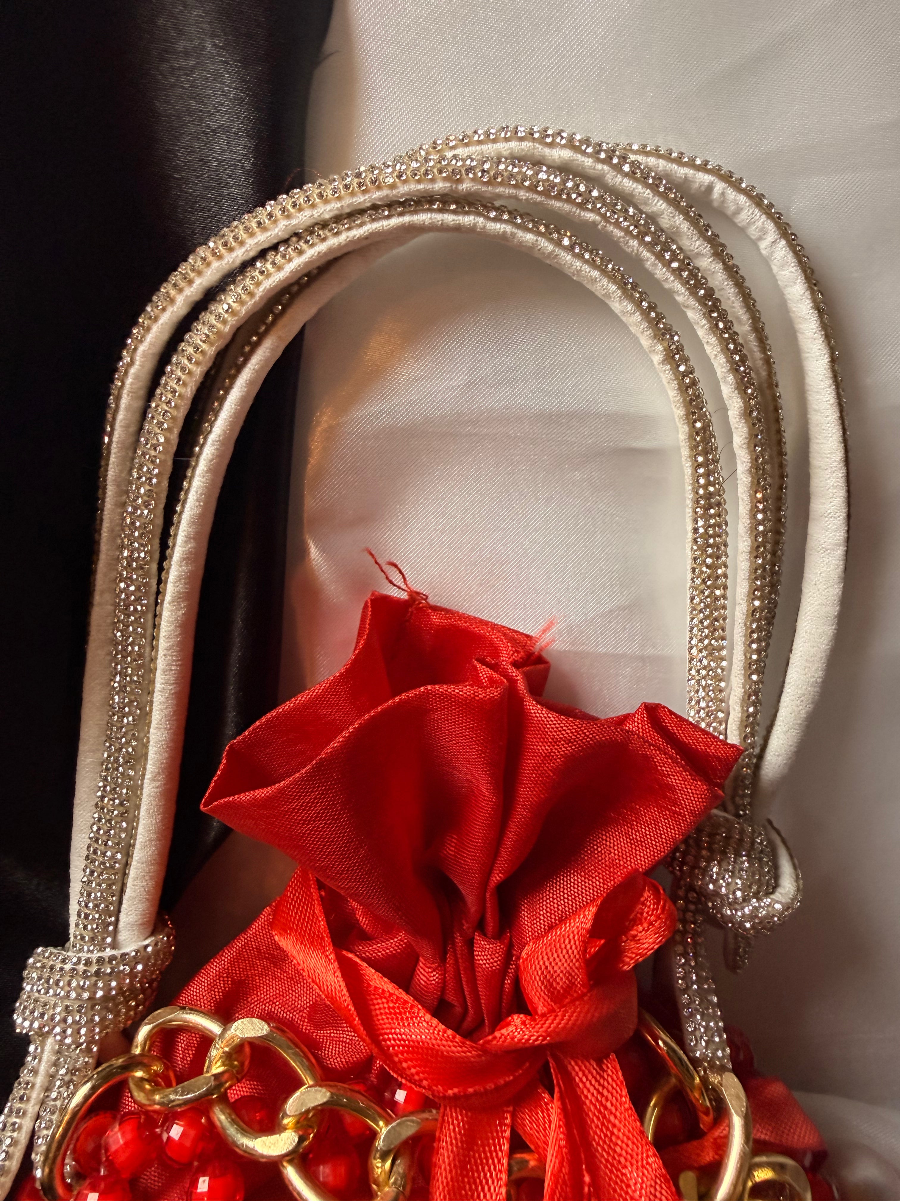 Decorative item with red fabric and gold accents on a neutral background