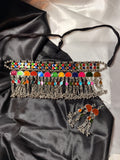 Colorful beaded choker necklace on black satin fabric