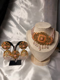 Ornate jewelry set on a white fabric background